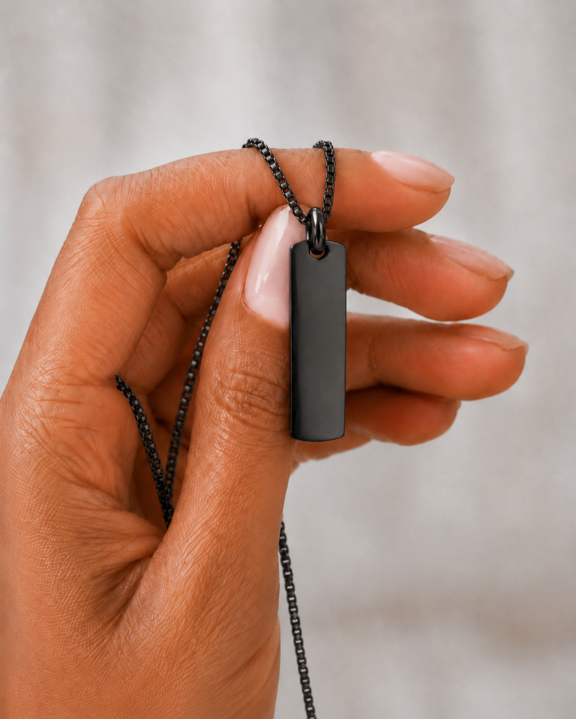 Hand holding Black Building Block pendant