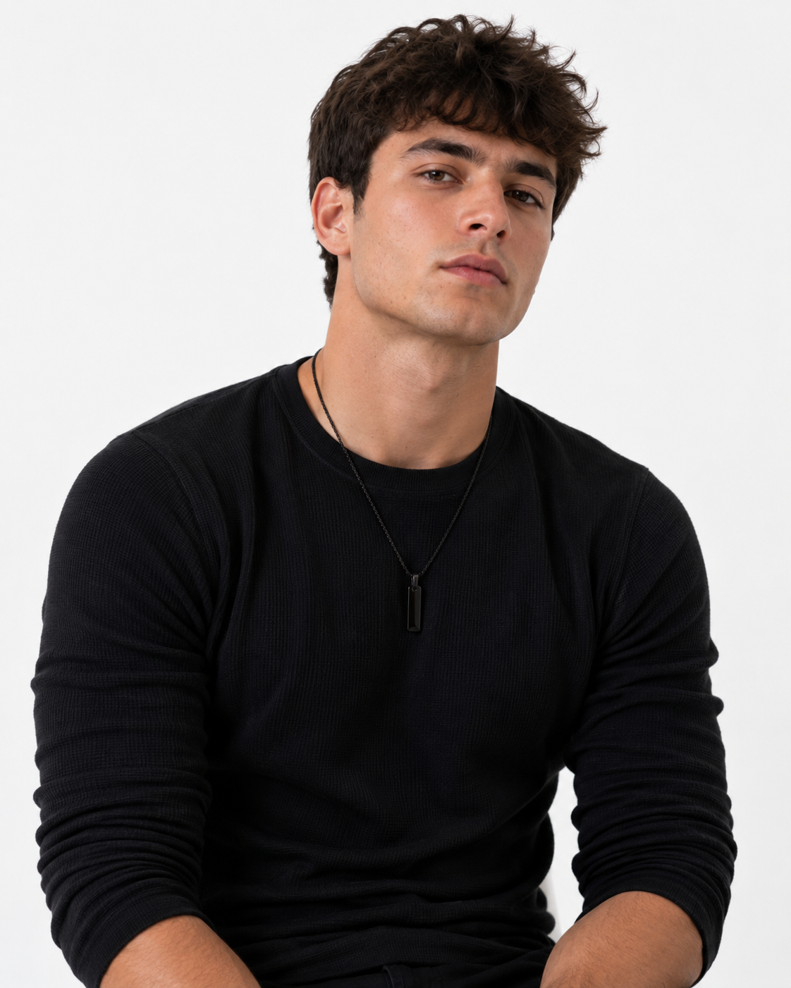 Model in black shirt wearing the Black Building Block pendant
